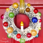 vintage bottlebrush wreath that has been decorated with vintage ornaments