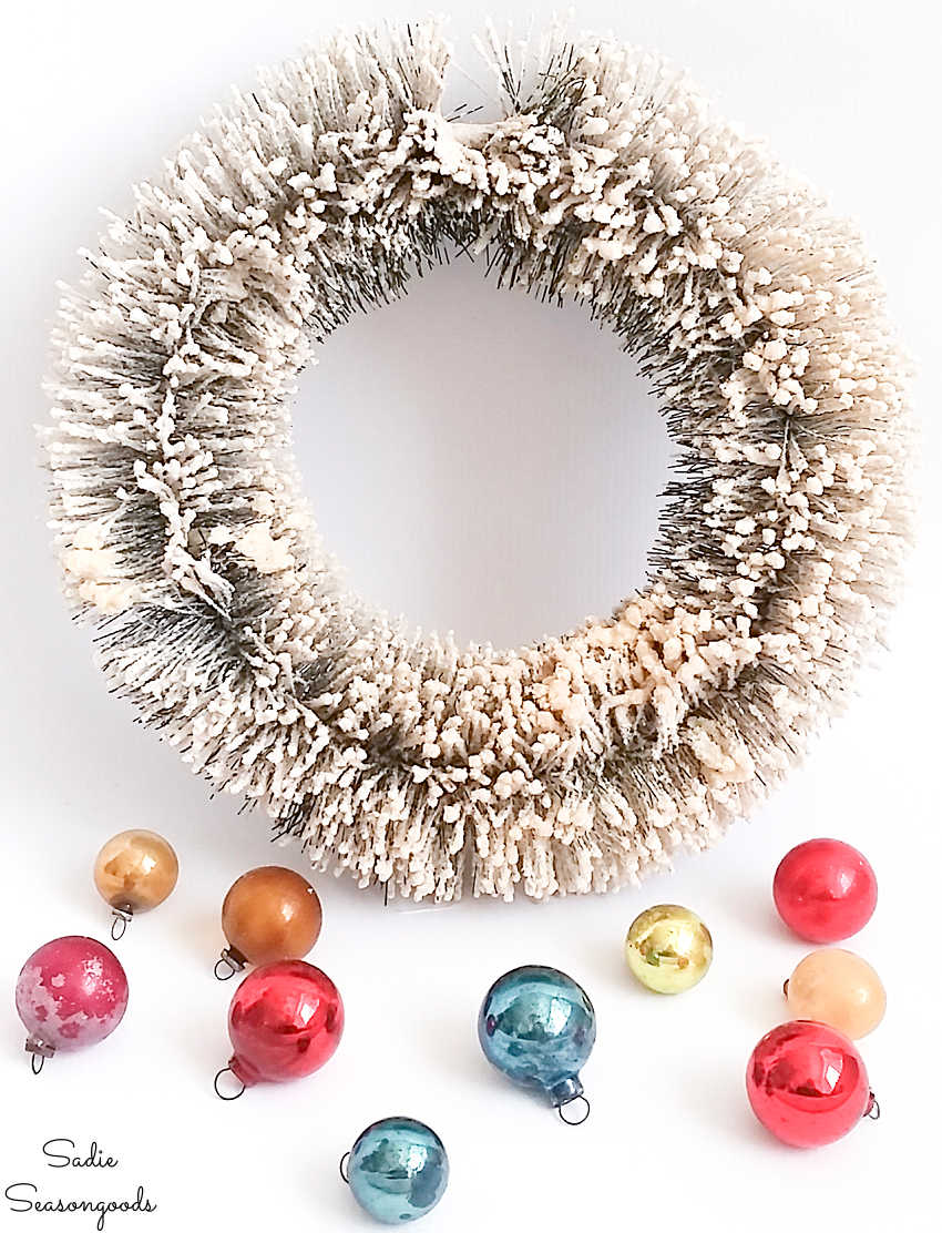 decorating a bottlebrush wreath with vintage ornaments