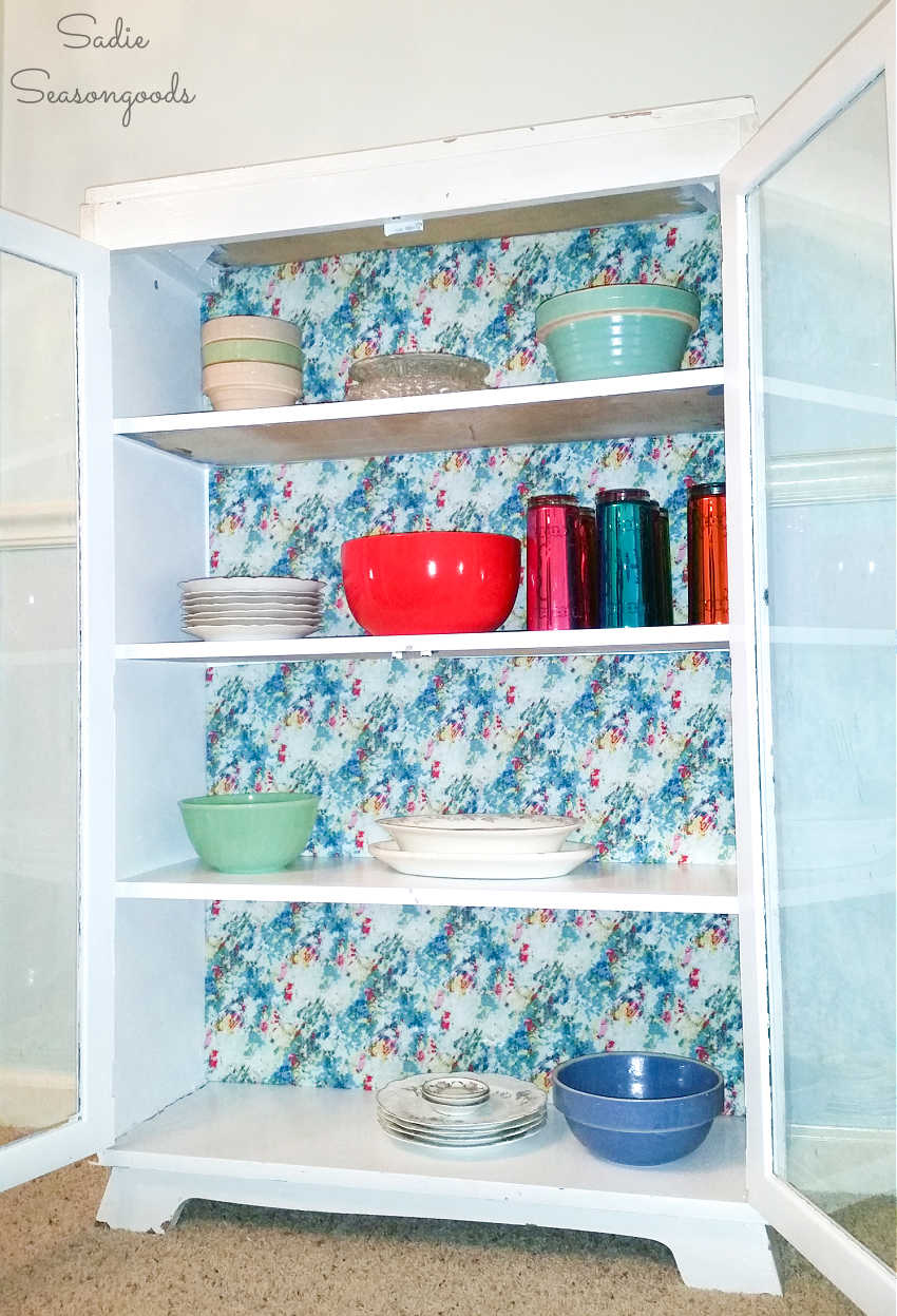 decorating the back of shelves with fabric wrapped cardboard
