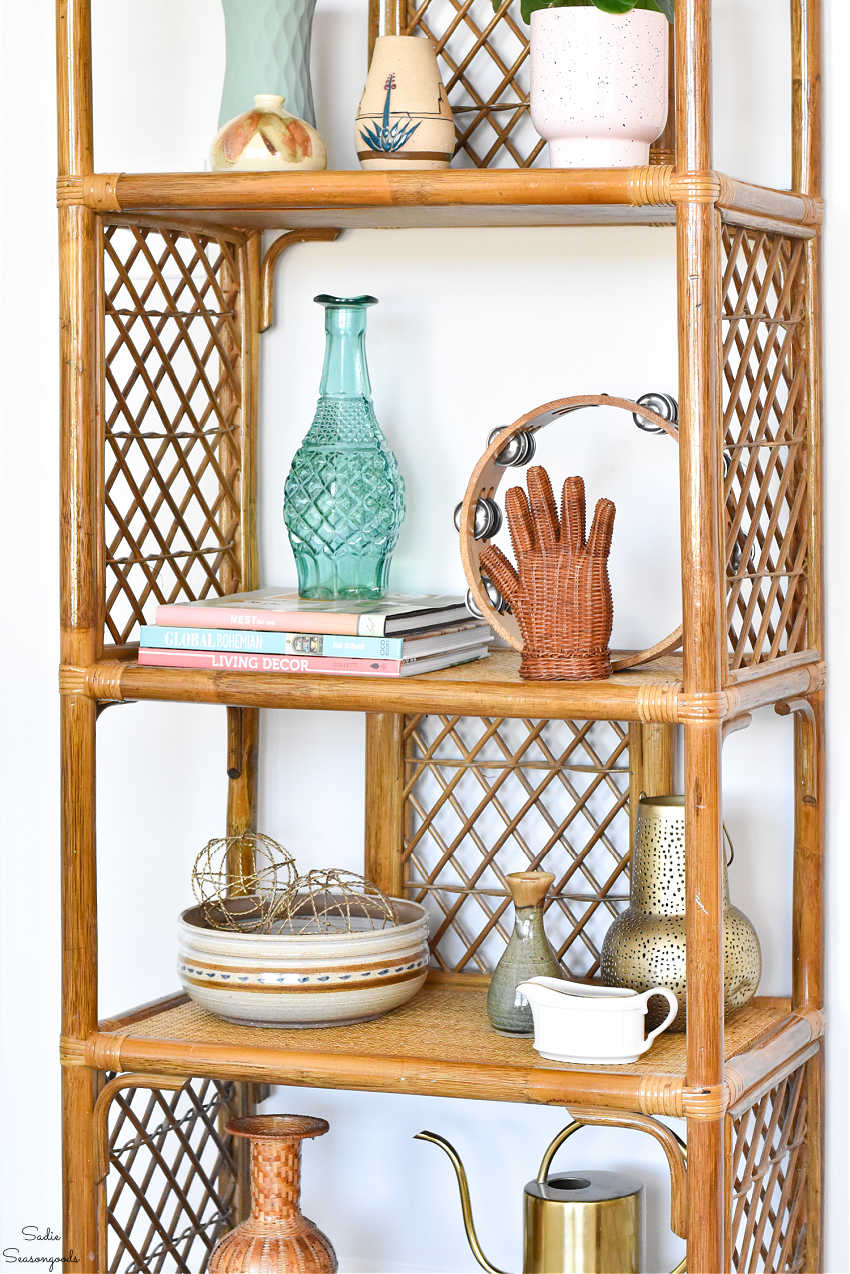 vintage bamboo bookshelf with thrifted decor