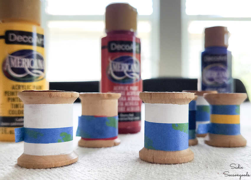 painting the wooden spools like nautical flags