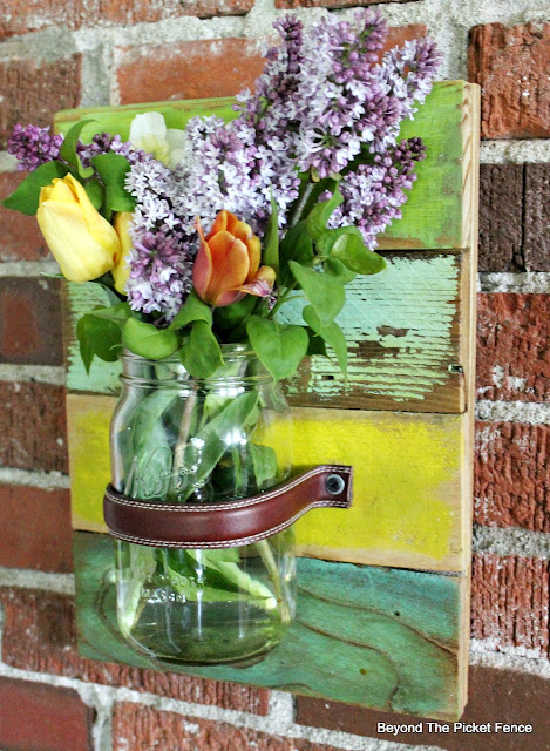 wall sconce with a mason jar and leather belt
