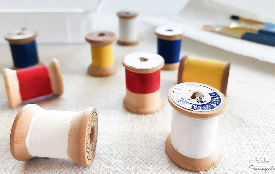 painting wooden spools like nautical flags