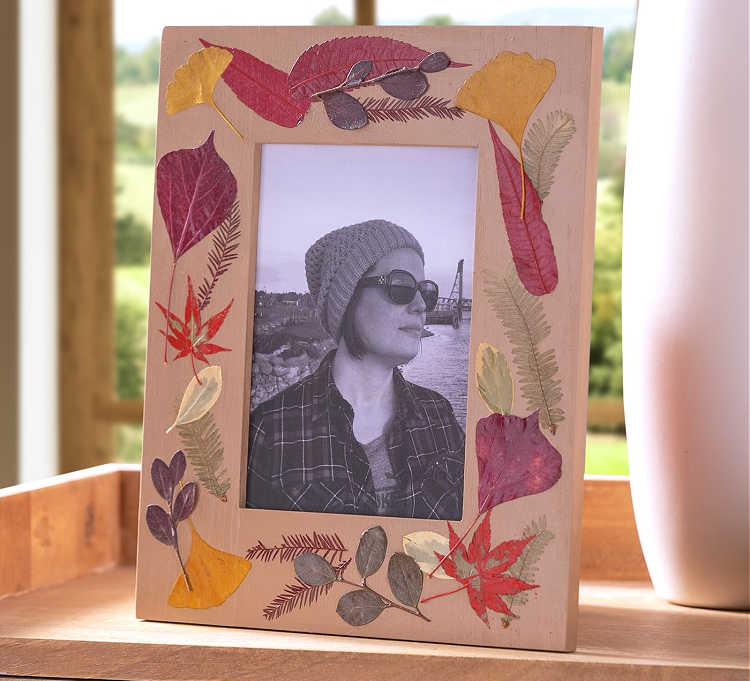 decorating a frame with fall leaves