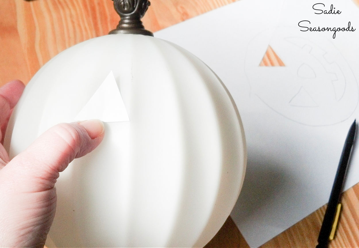 tracing the face on a light-up jack-o-lantern