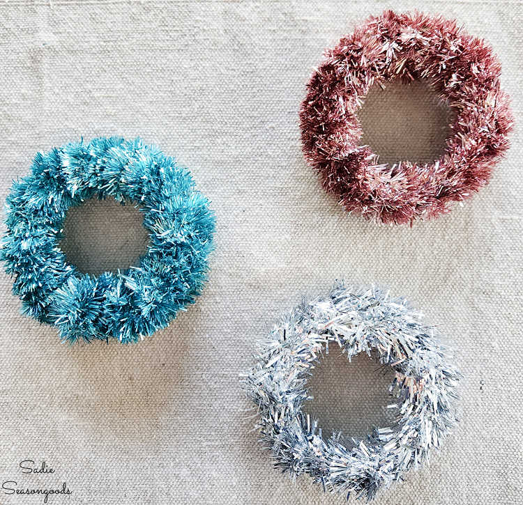 mini tinsel wrapped around mason jar lids