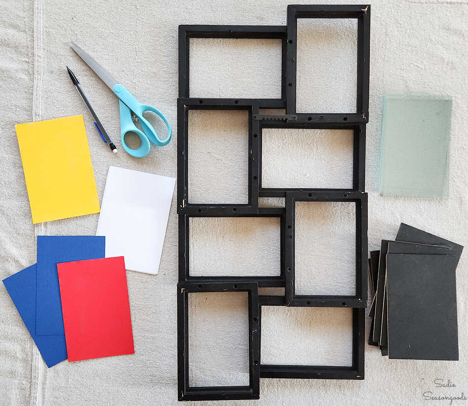 filling the black collage frame with cardstock in red, blue, yellow, and white