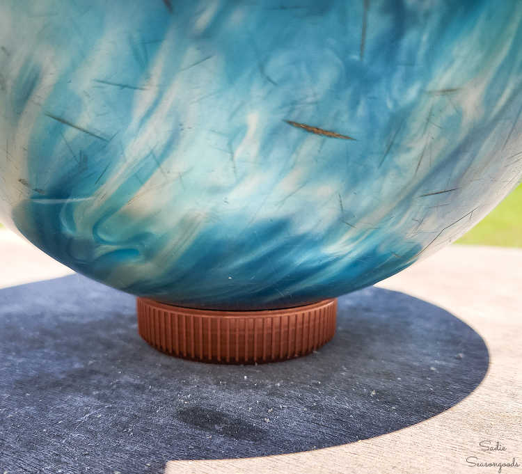 preparing to clean and spray a bowling ball