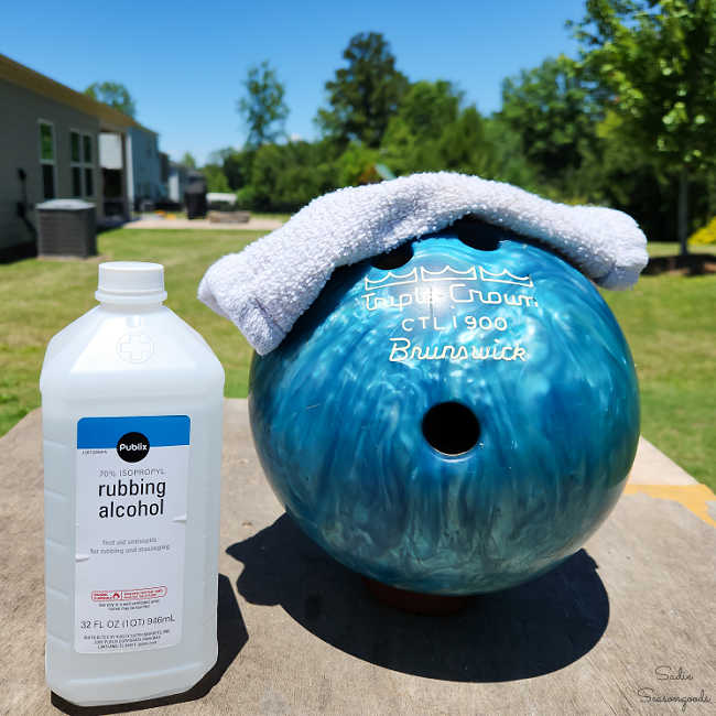 wiping down a ball with rubbing alcohol