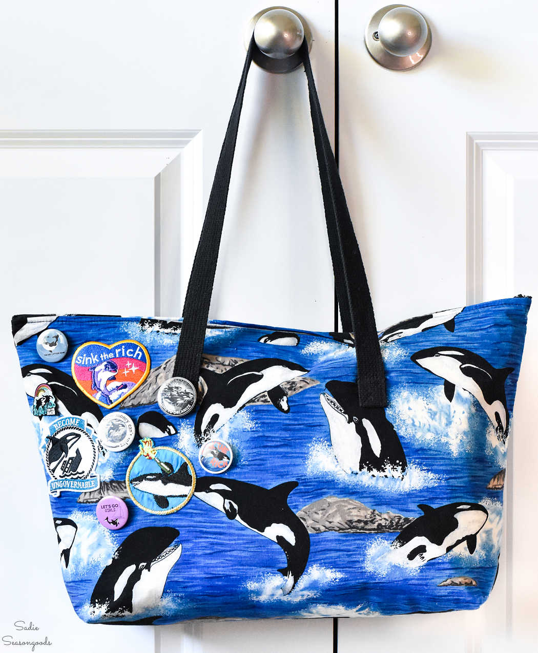 sink the rich patches on an orca tote bag