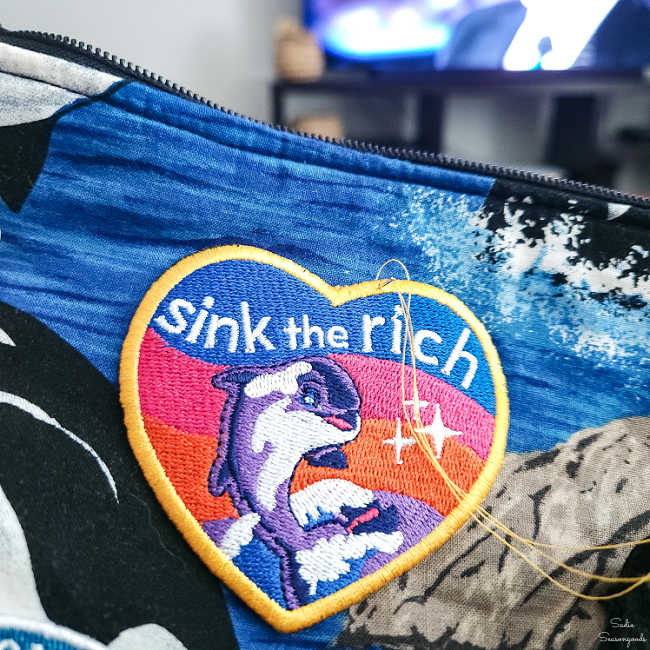 stitching patches onto a fabric tote bag