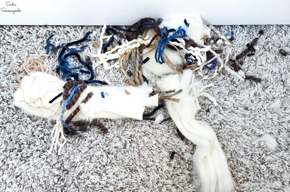 trimming a diy yarn wall hanging