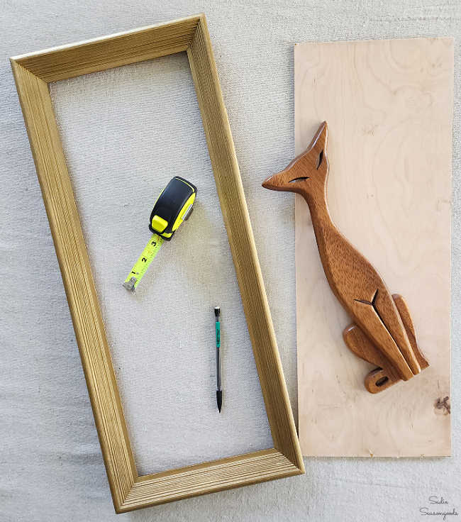 cutting out a piece of plywood to go inside a vintage frame